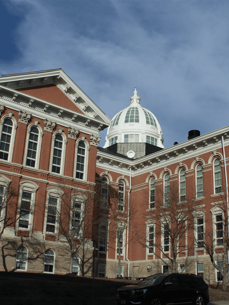 Historic courthouse building with dome in downtown quest for directions.
