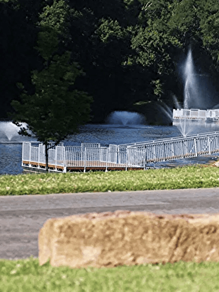 Serene water fountain with cascading waterfalls and scenic greenery at Quest For Directions park.