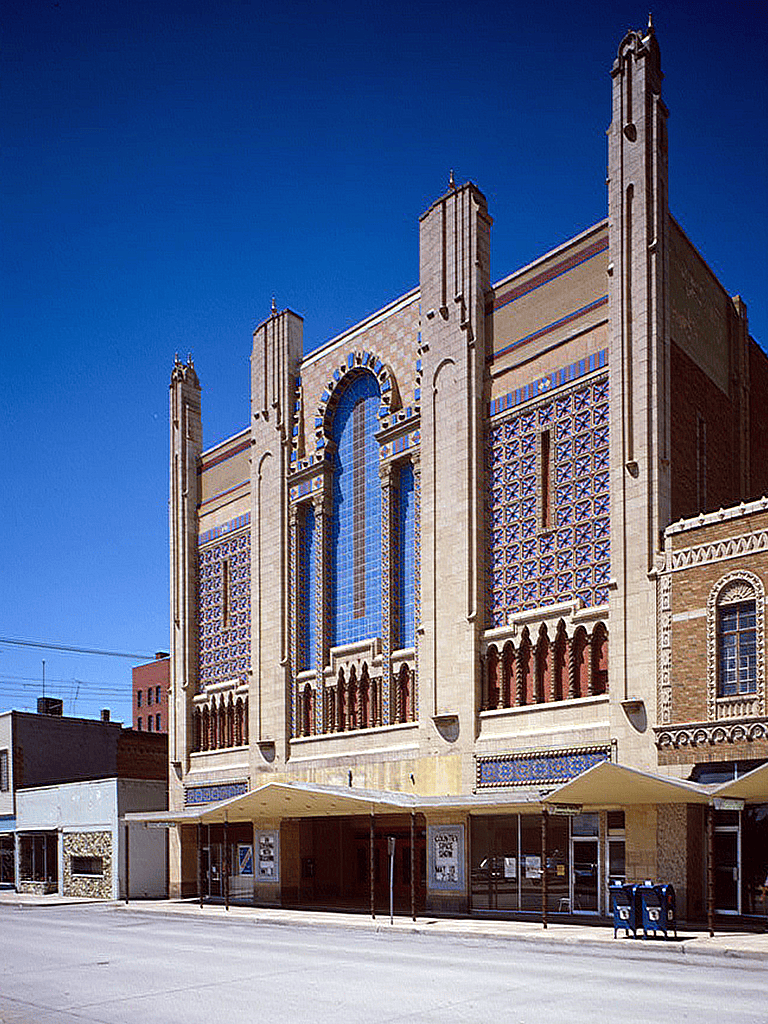 Victorian-style historic building with blue and beige tile accents in downtown area.
