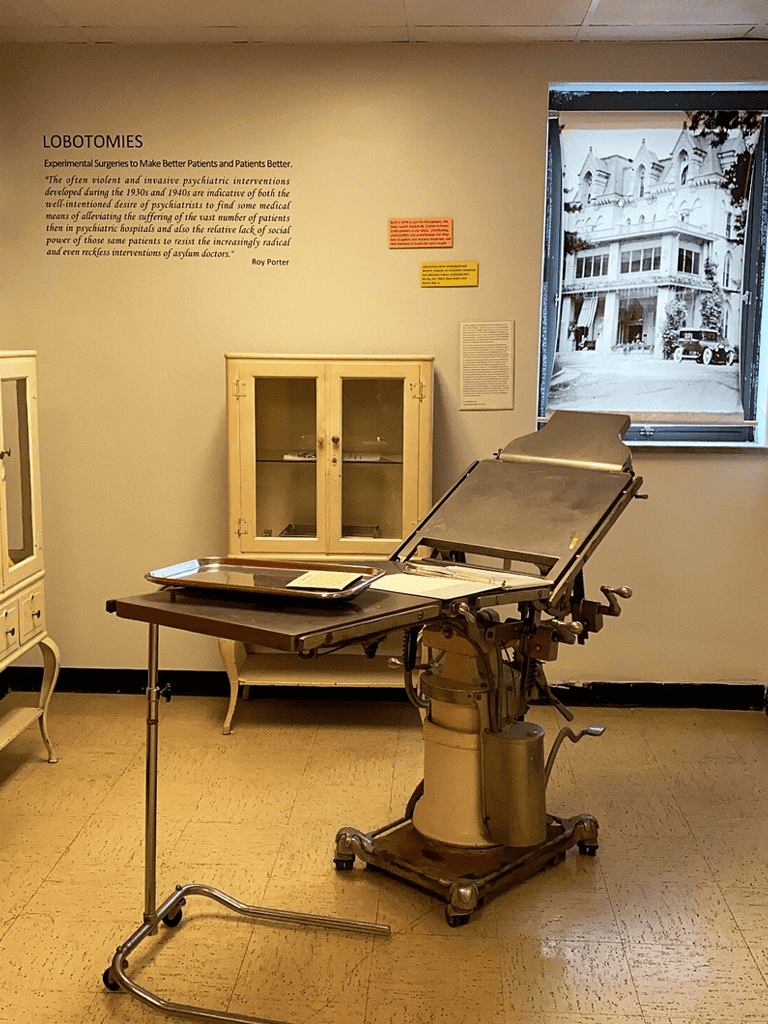 Medical examination table in a historical medical exhibit room.