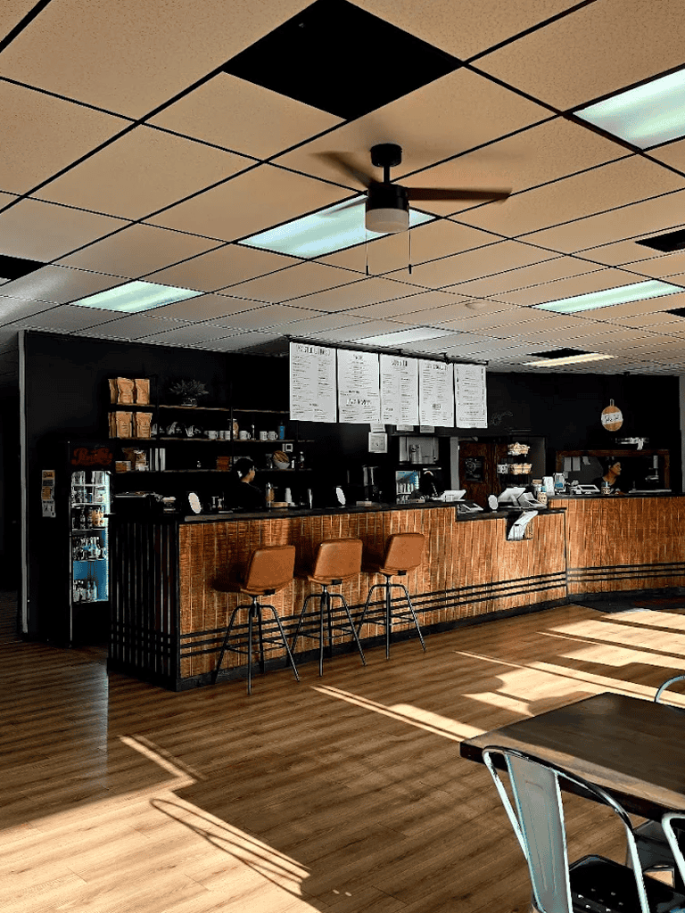 Cozy café interior at QuestForDirections, warm wood accents and modern lighting perfect for studying or meeting friends.