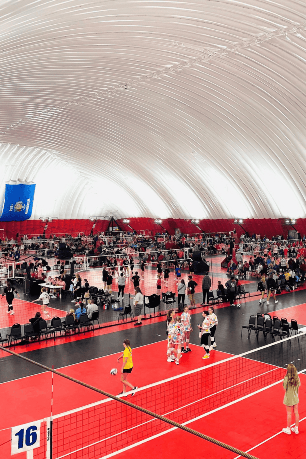 Indoor volleyball game at QuestForDirections sports complex, showcasing a lively tournament atmosphere.