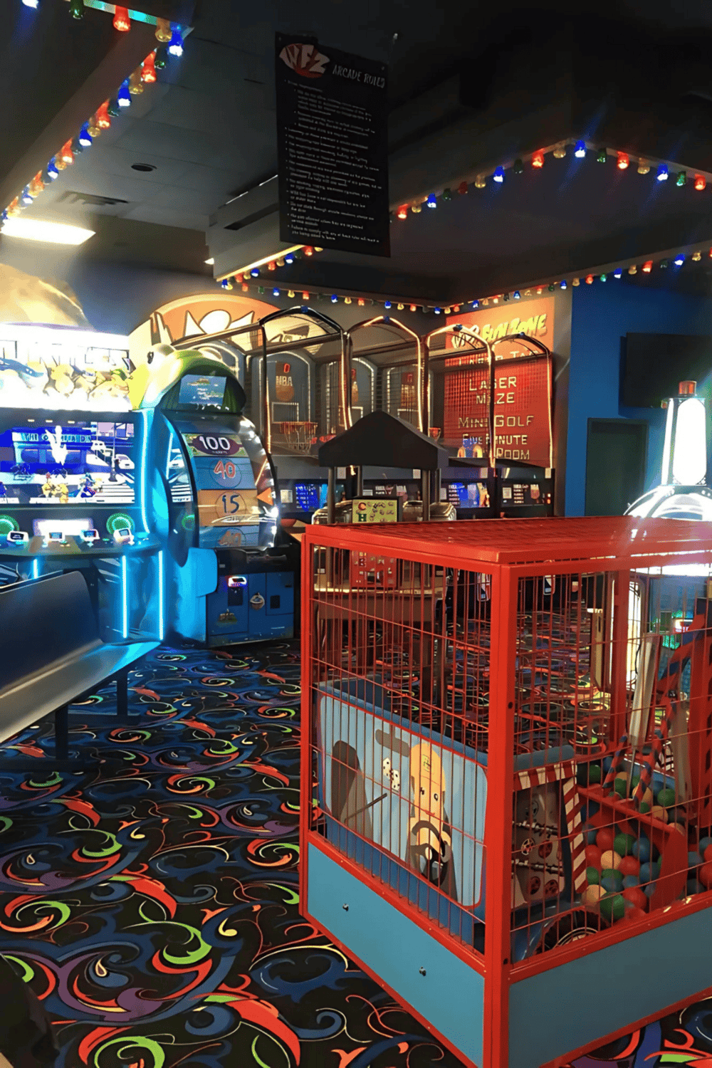 Bright arcade game machines and colorful ball pit at QuestForDirections indoor entertainment center.