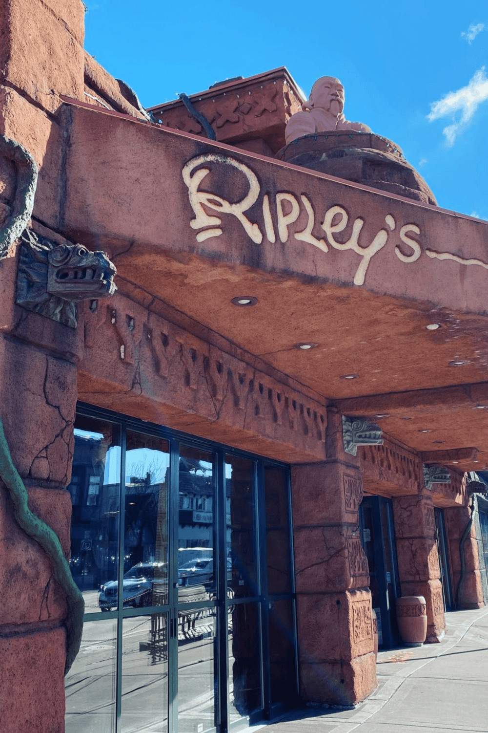 Ripleys attraction storefront with themed architecture and dinosaur sculptures, popular tourist destination for family fun.