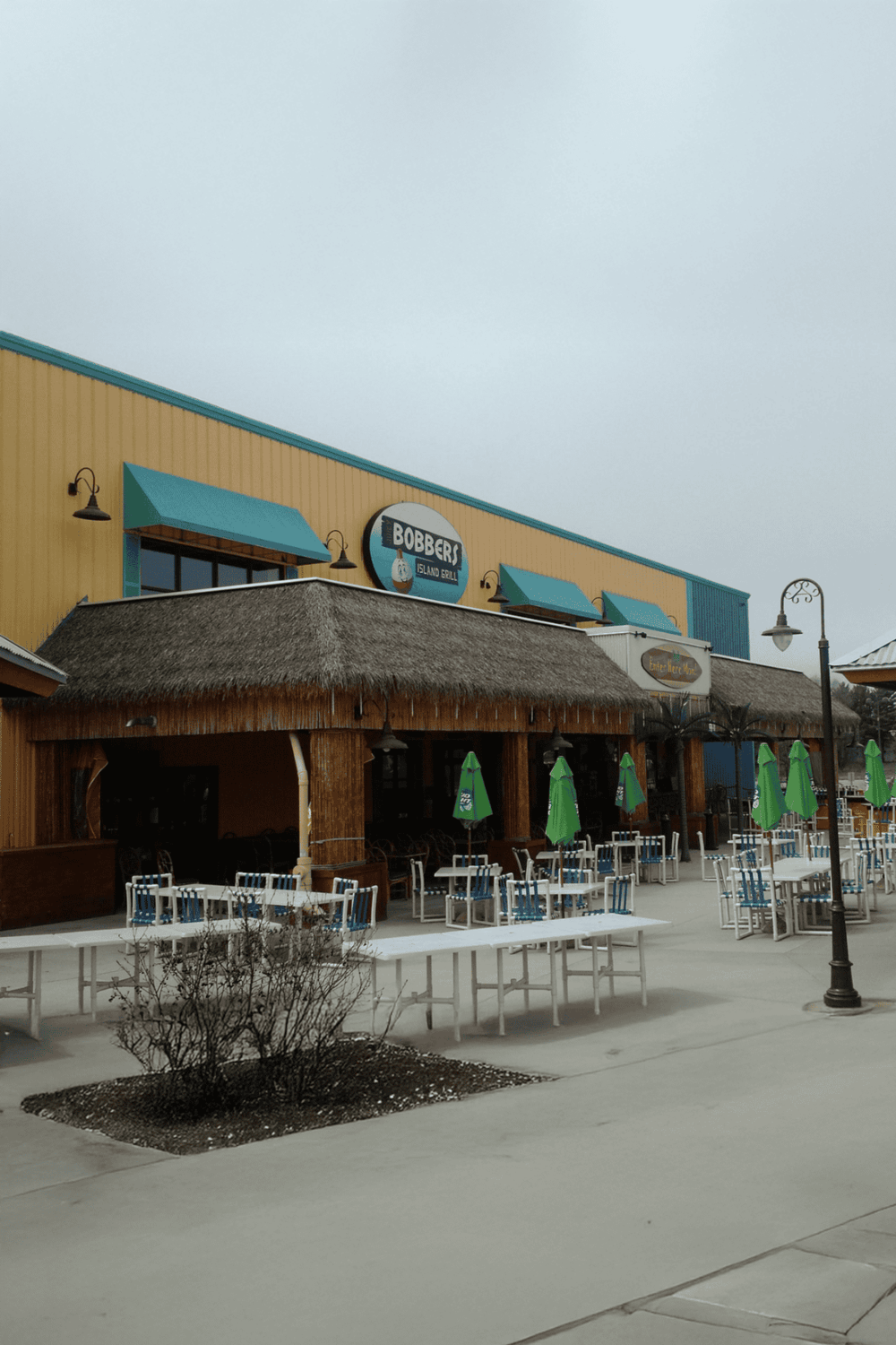 1. Island grill restaurant with outdoor seating and tropical decor, perfect for dining with family.