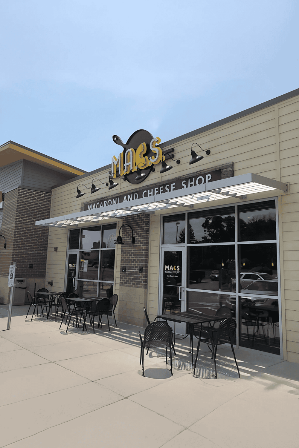 Freshly baked mac and cheese shop with outdoor seating, modern decor, and a welcoming ambiance.