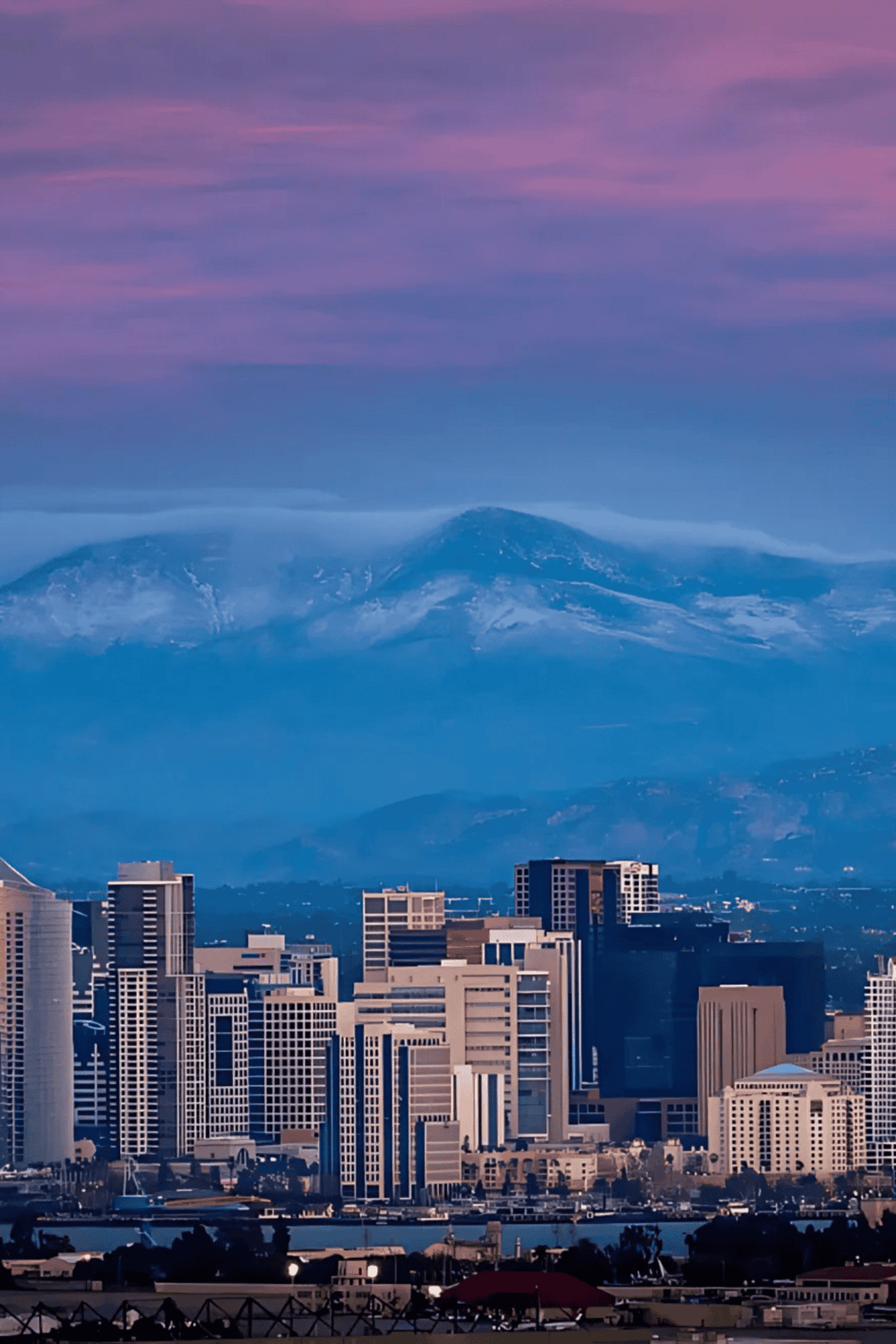 Vibrant city skyline with Mount San Gorgonio in the background, showcasing scenic California urban and mountain views.
