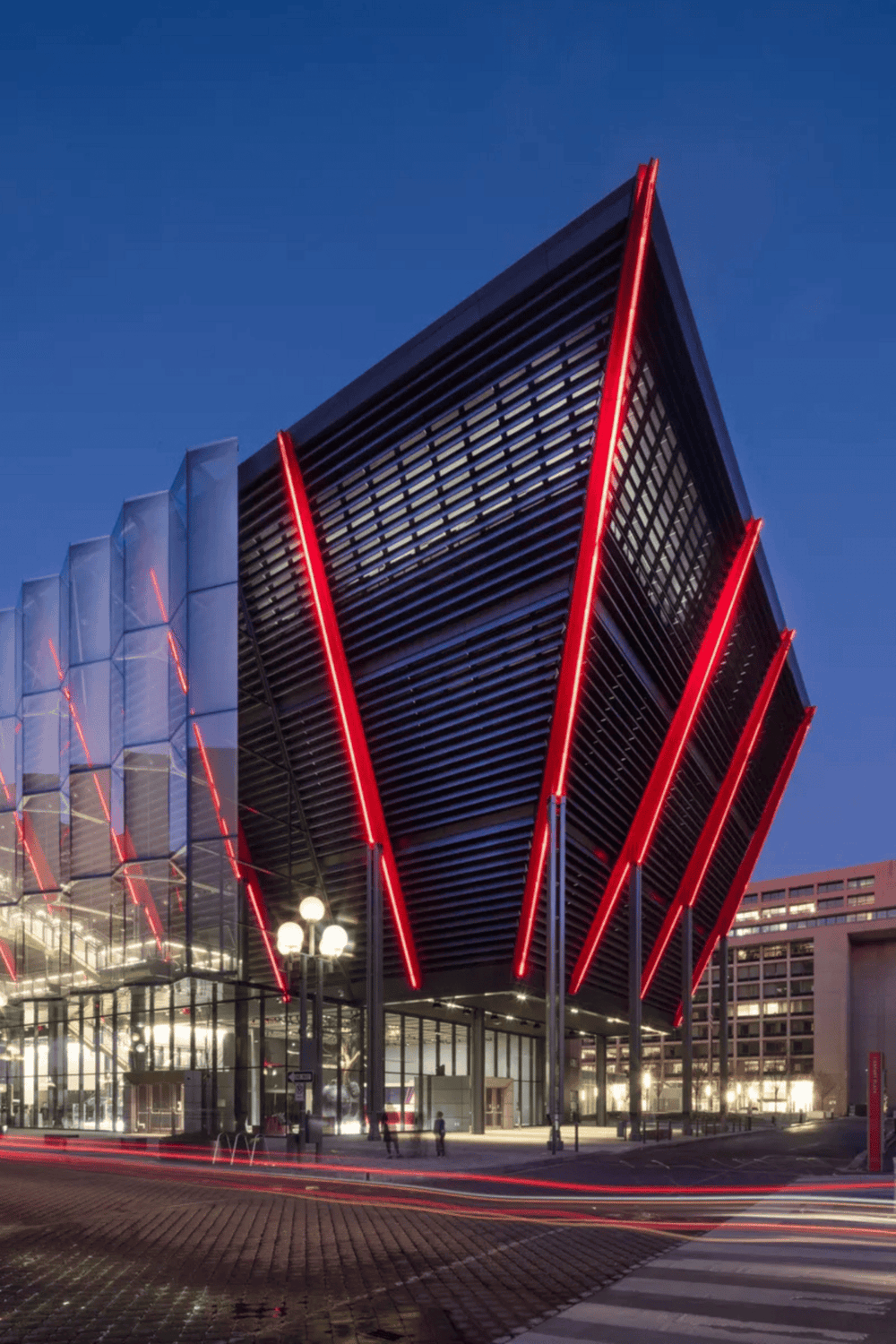 Innovative modern building with bold architectural design and red LED accents, highlighting urban development and cityscape.