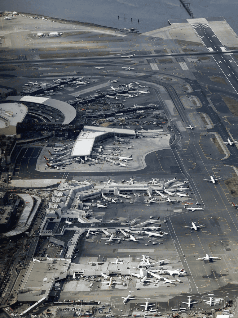 Planes parked at international airport, aerial view of aircraft terminal and runway.
