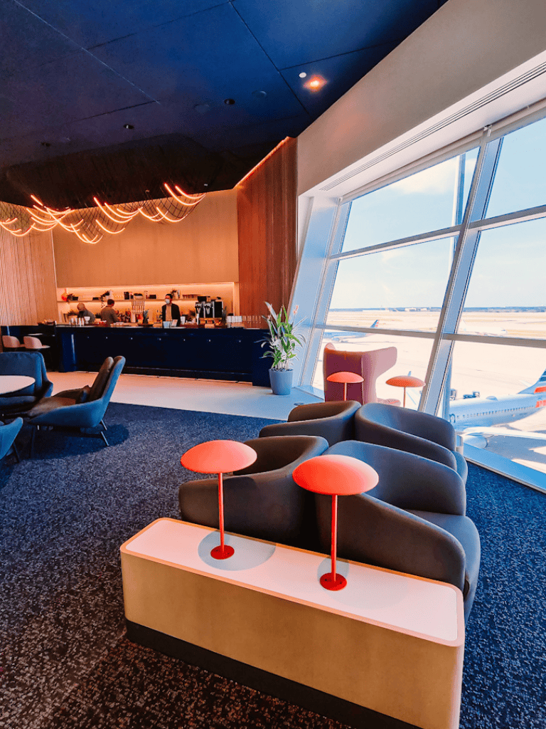 Comfortable airport lounge at QuestForDirections with modern seating and scenic runway views.