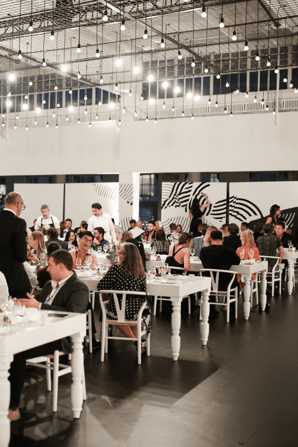 Elegant dining event at QuestForDirections, showcasing a modern, stylish restaurant interior with vibrant ambiance and guests enjoying fine cuisine.