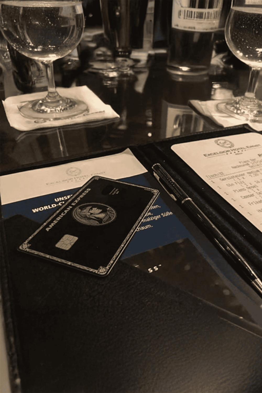 Credit card and dining setup at a restaurant table for mobile app navigation.