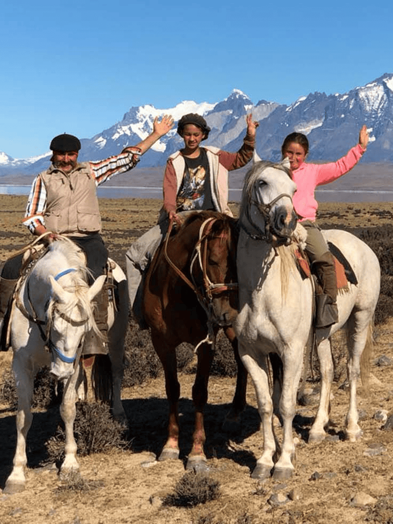 Happy travelers riding horses in scenic mountains setting at QuestForDirections.
