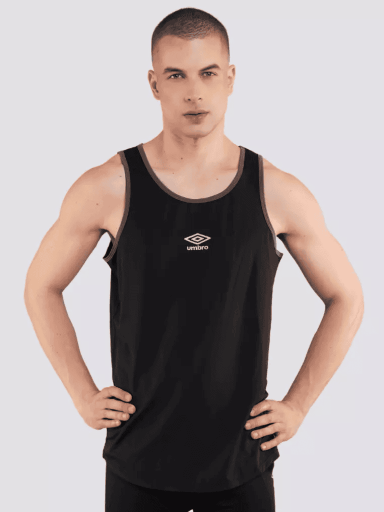 Young man in black sports tank top with "Umbro" logo on white background.