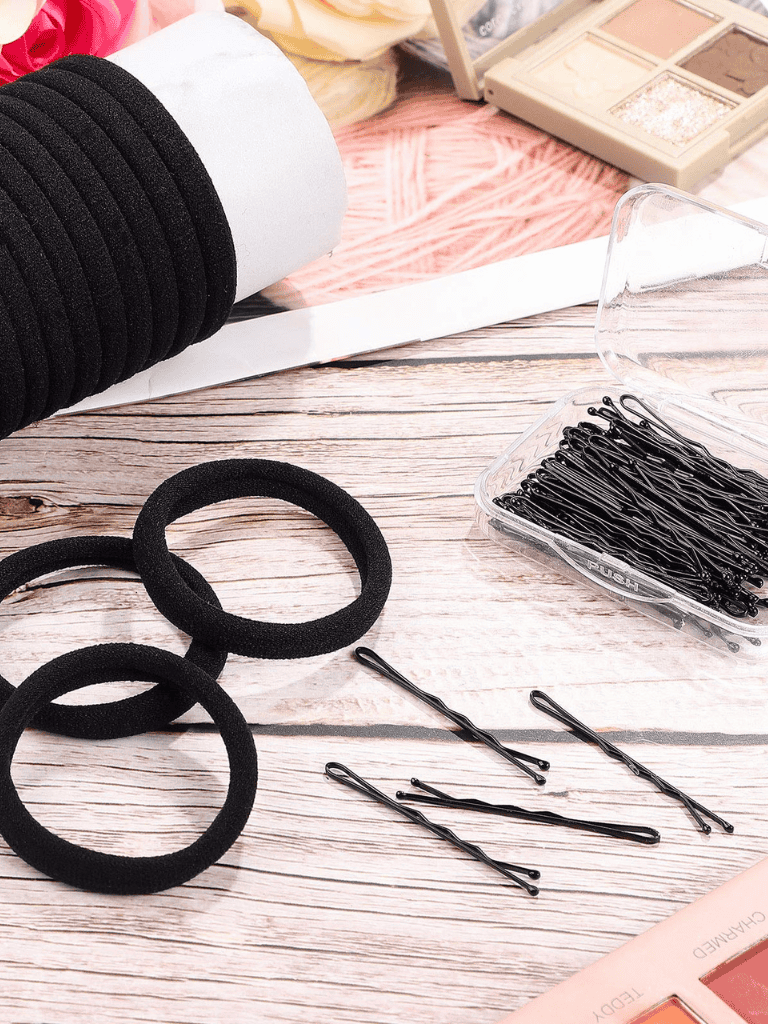 Silicone hair ties, bobby pins, and hair accessories on a wooden surface for styling and hair care.