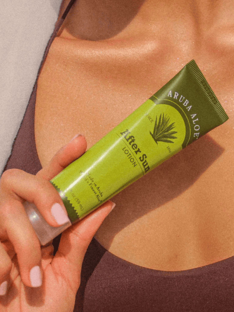Aloe Vera lotion on woman’s chest promoting skin hydration and health.
