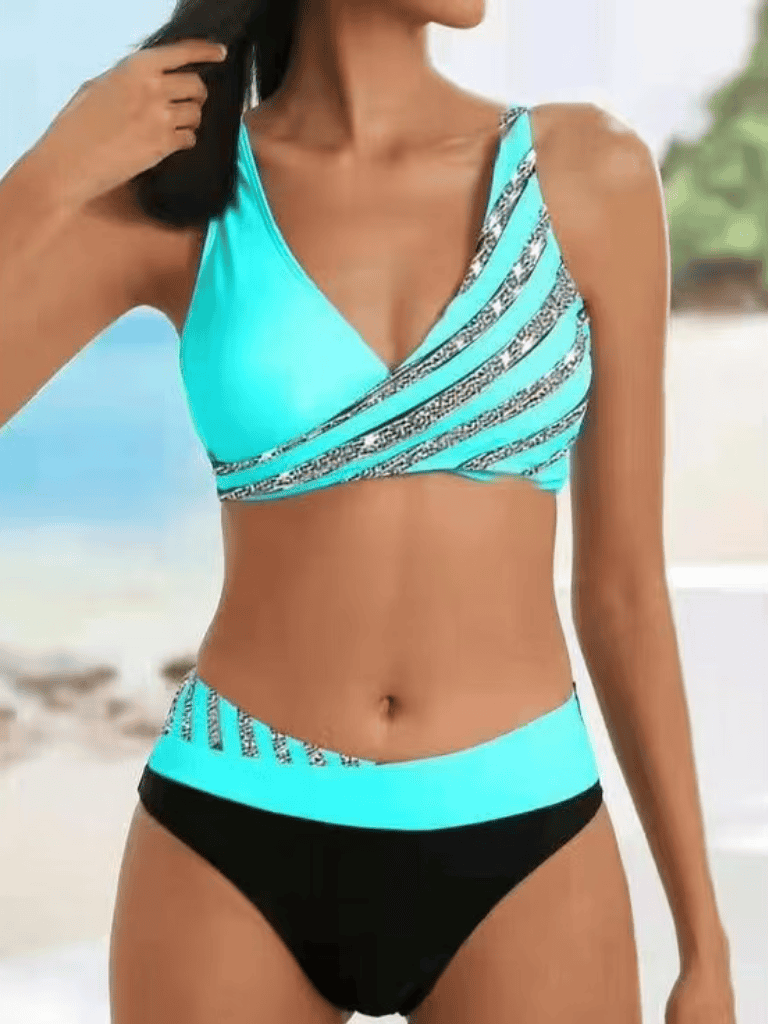 Bright blue and black swimsuit with zebra stripe accents, perfect for beachwear or swimming.