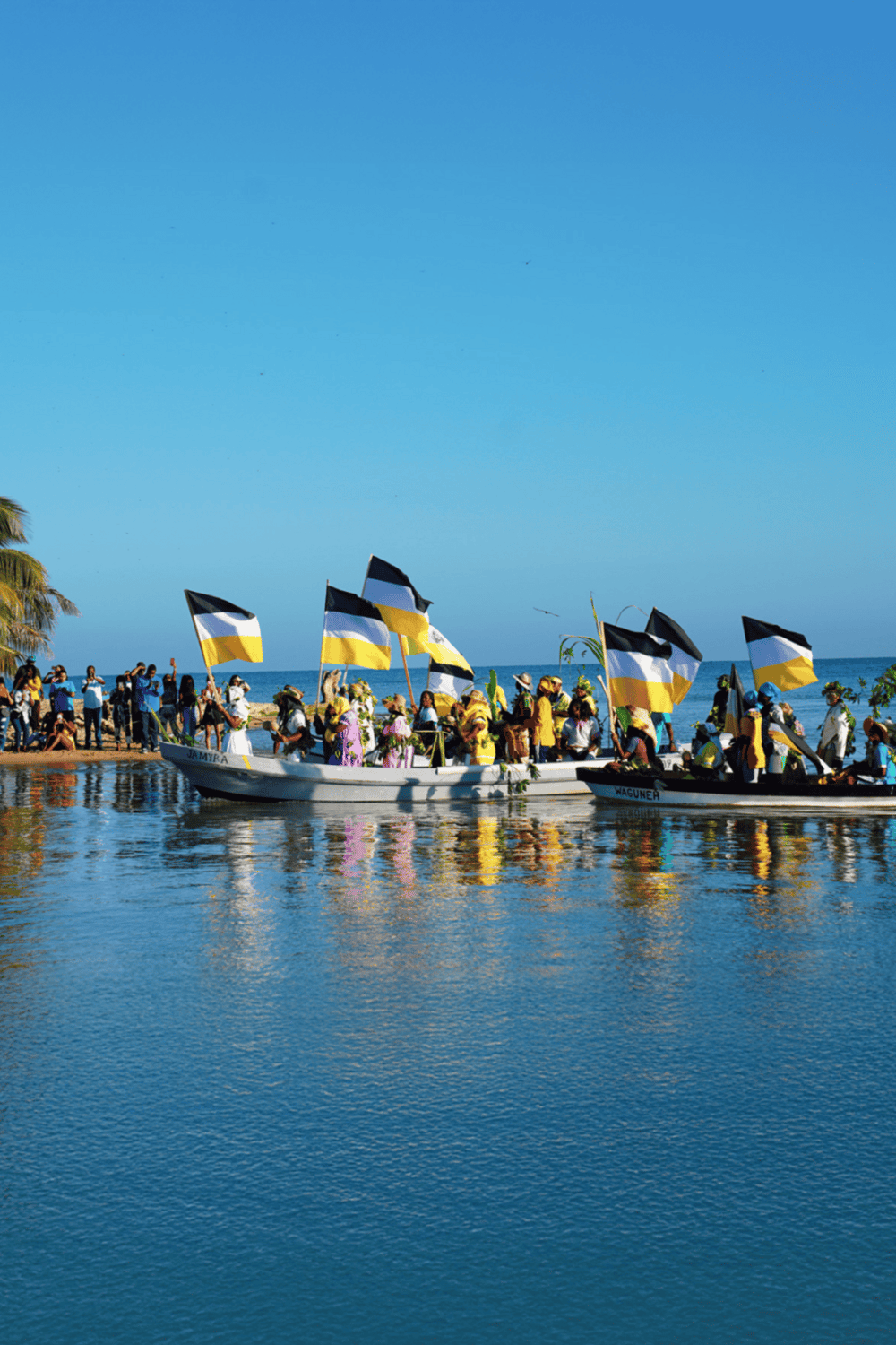 Colorful boats with flags at a waterfront celebration, promoting travel and recreational activities.