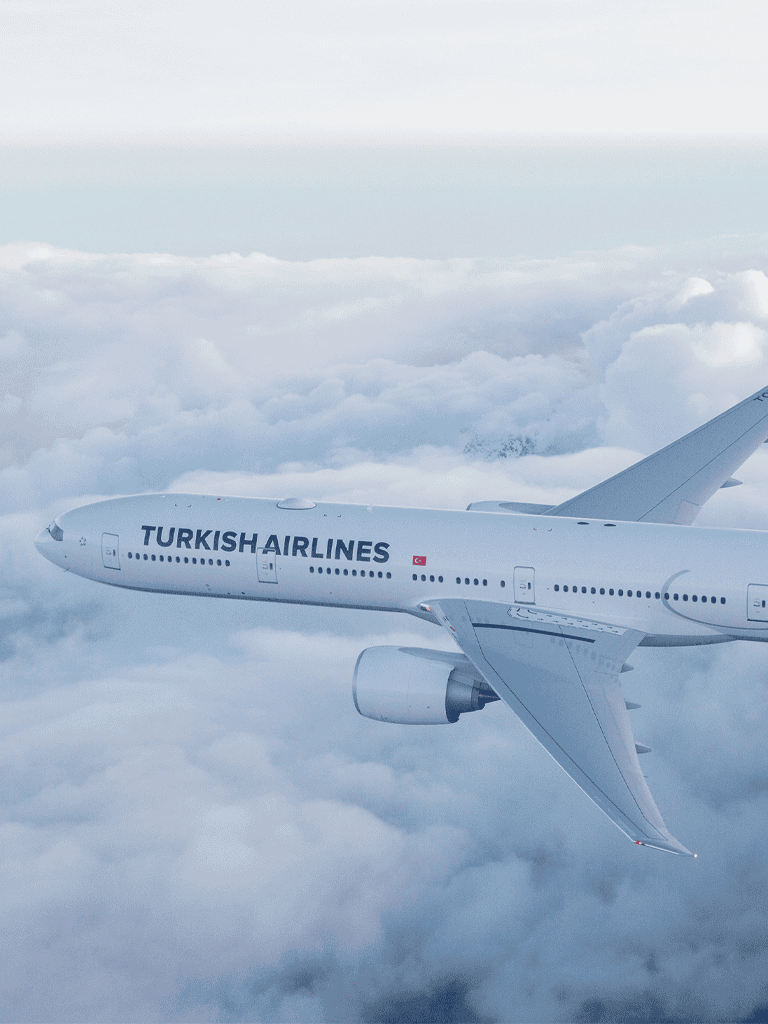 Turkish Airlines airplane flying above clouds, travel, aviation, airline, flight, sky, aircraft, transportation, international travel, passenger jet.