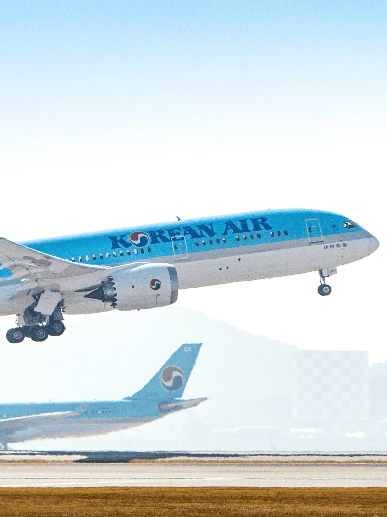 Korean Air airplane taking off from runway, modern aircraft at airport.