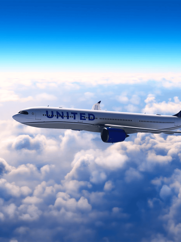 Commercial airplane flying above clouds, United Airlines flight in the sky, air travel destination, airline transportation, aviation.