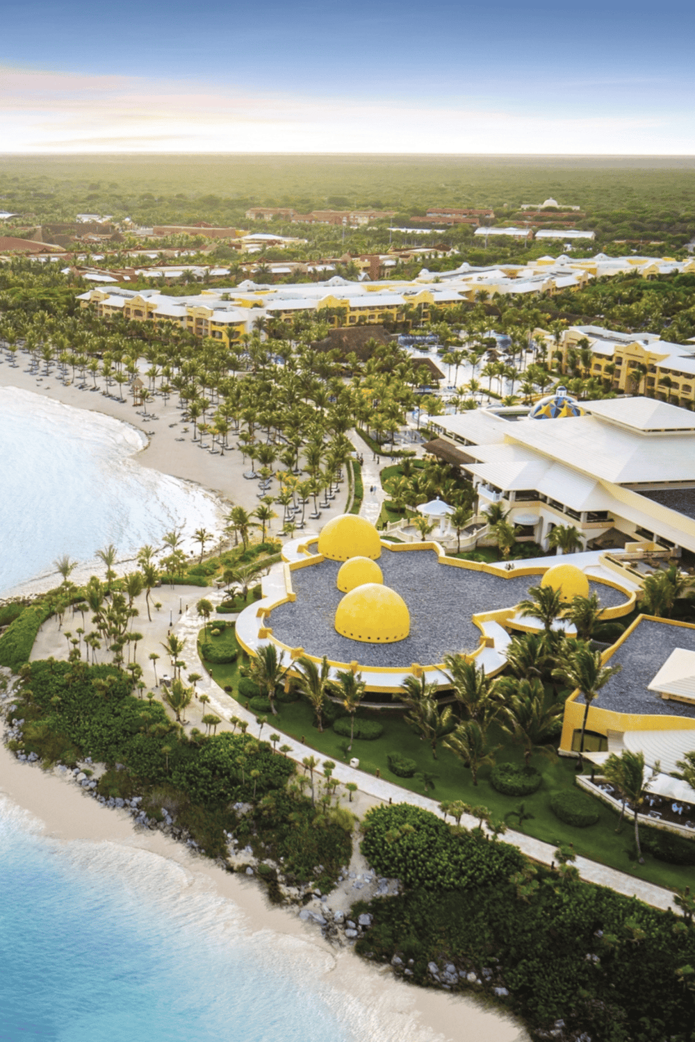 Luxury beachfront resort with tropical gardens and ocean views in Cancun, Mexico.