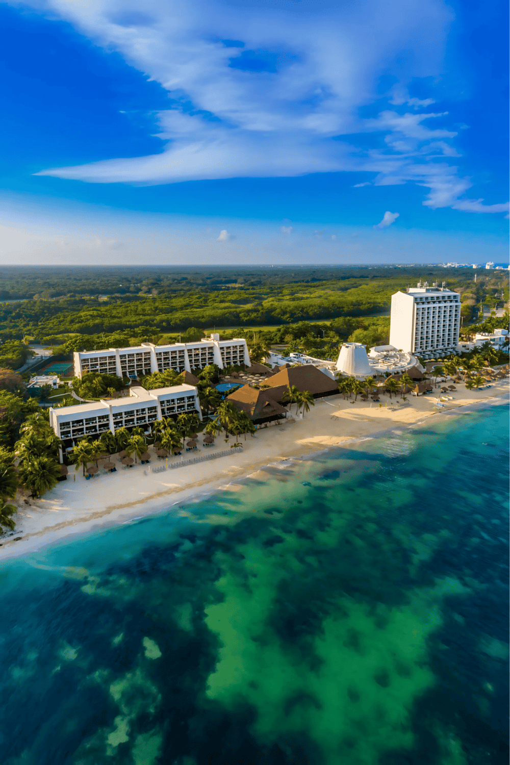 Luxury beachfront resort with ocean views and lush greenery, ideal for vacations in paradise.
