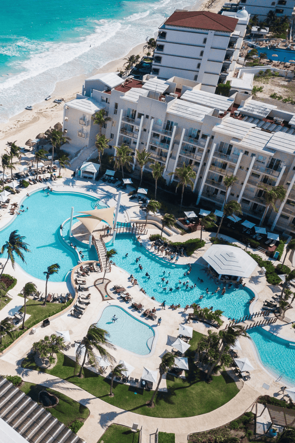 Luxurious beachfront resort with pool, ocean views, and palm trees at QuestForDirections.