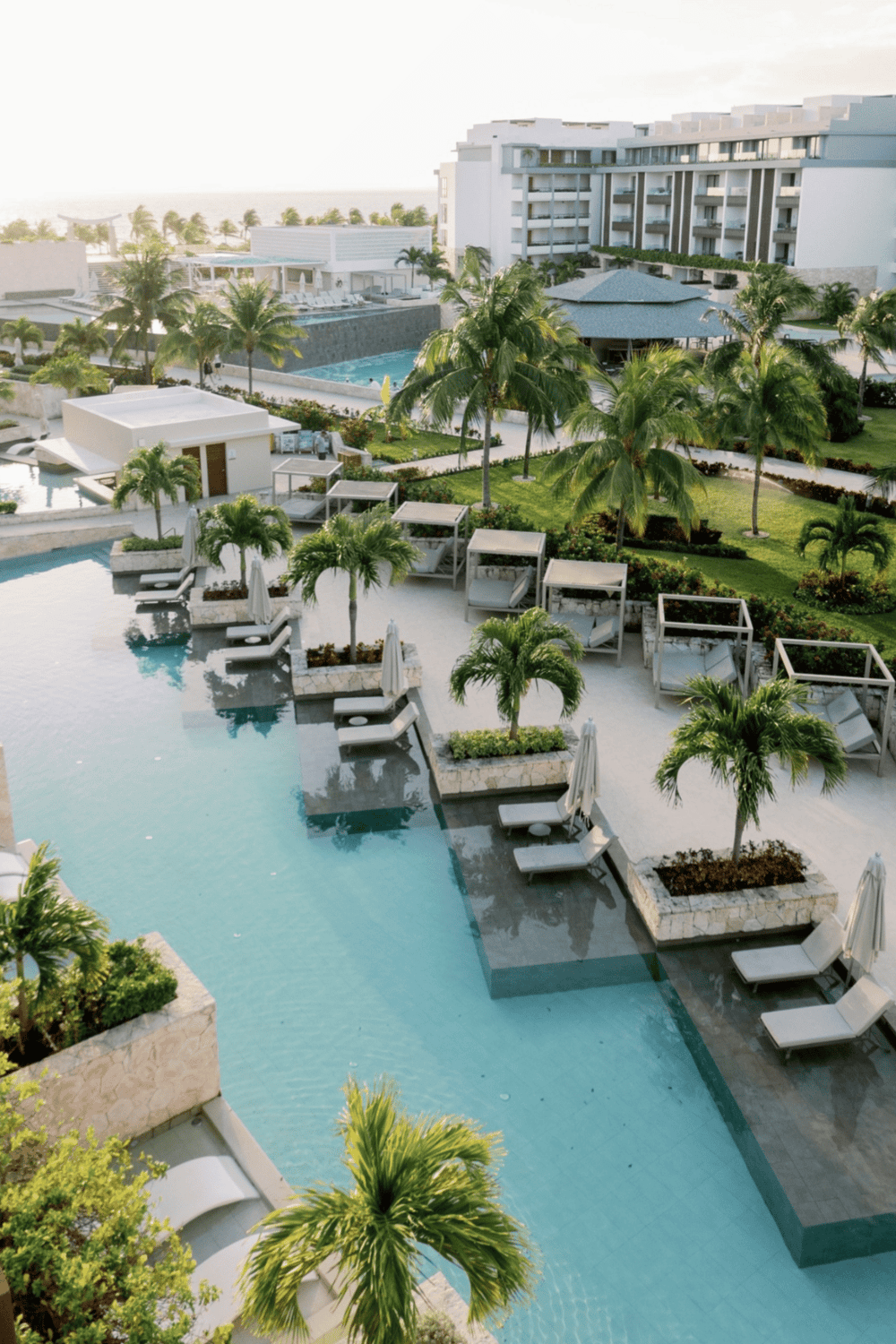 Luxurious tropical resort with swimming pool, lush greenery, and modern amenities.