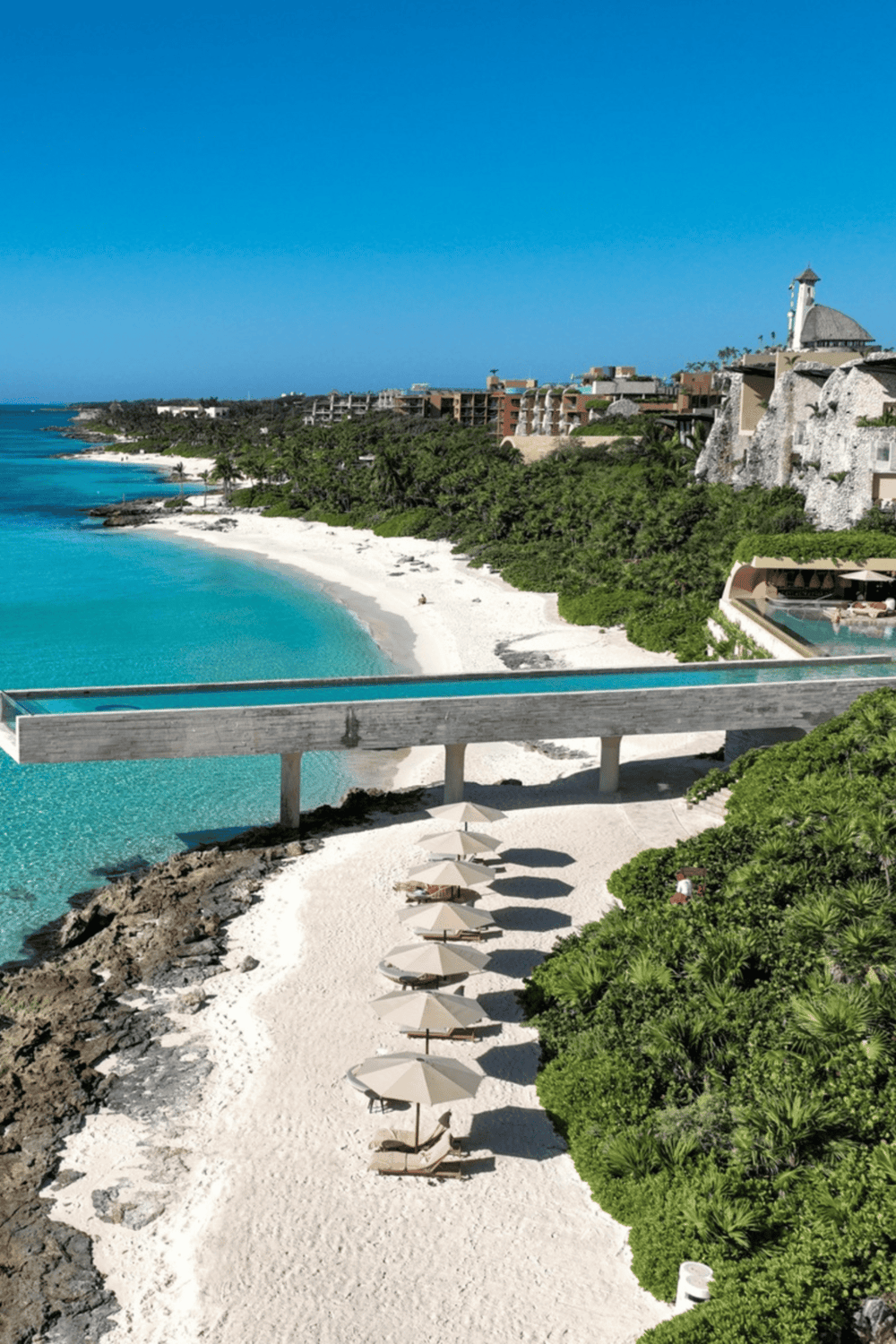 Secluded beach with turquoise waters, luxurious accommodations, and scenic ocean views at Quest For Directions.