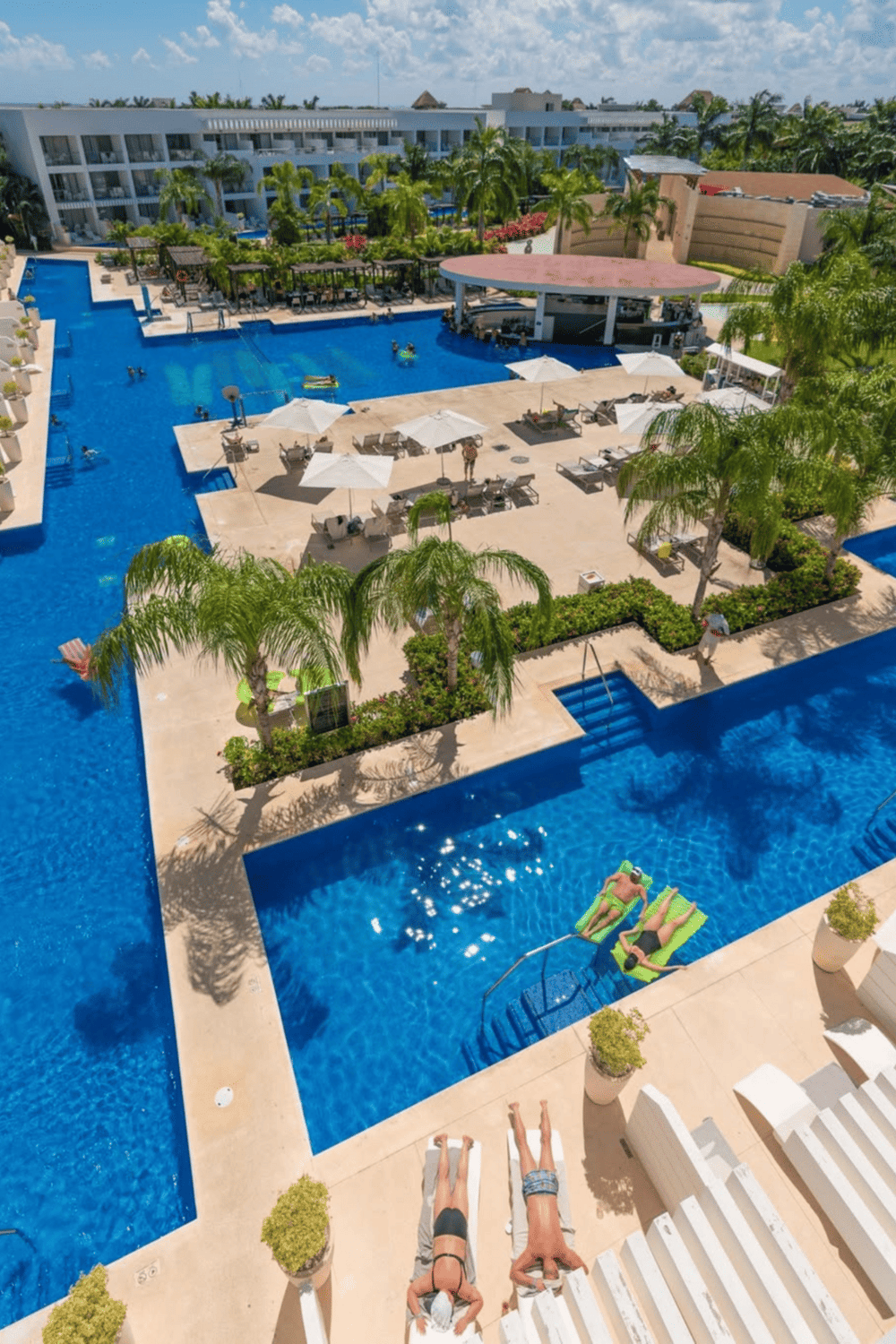 Swimming pool with ocean view at QuestForDirections hotel resort. Relaxing poolside lounge area with tropical landscaping.