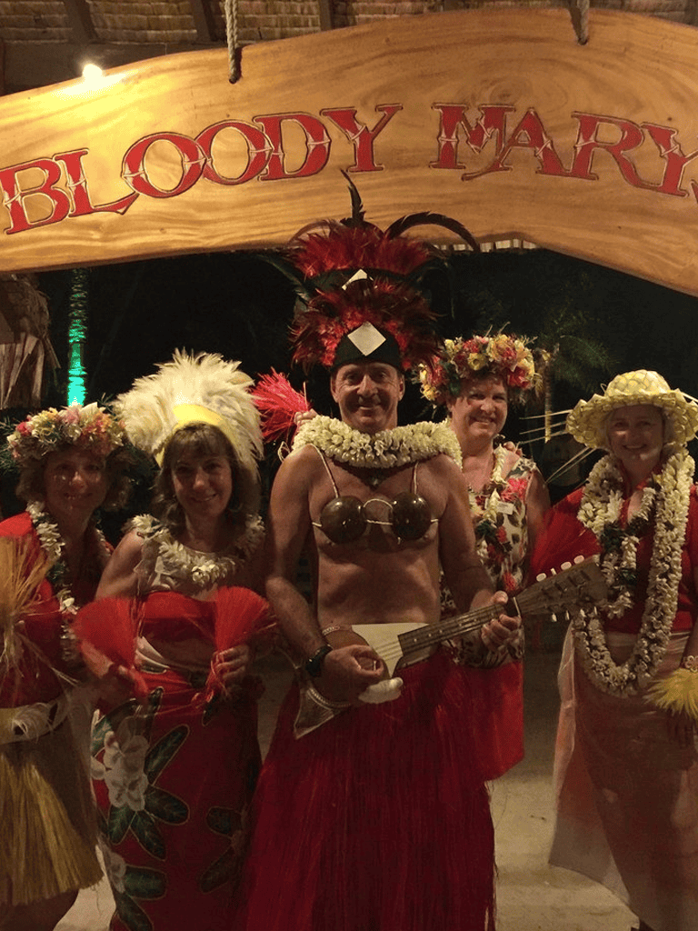 - traditional Hawaiian luau performers in colorful costumes and floral headpieces.