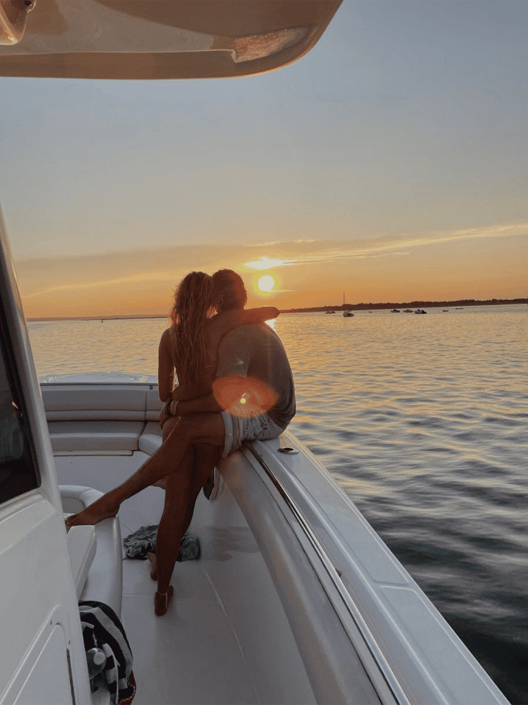 Peaceful couple enjoying sunset on boat, romantic waterway excursion, idyllic travel destination, Quest for Directions.