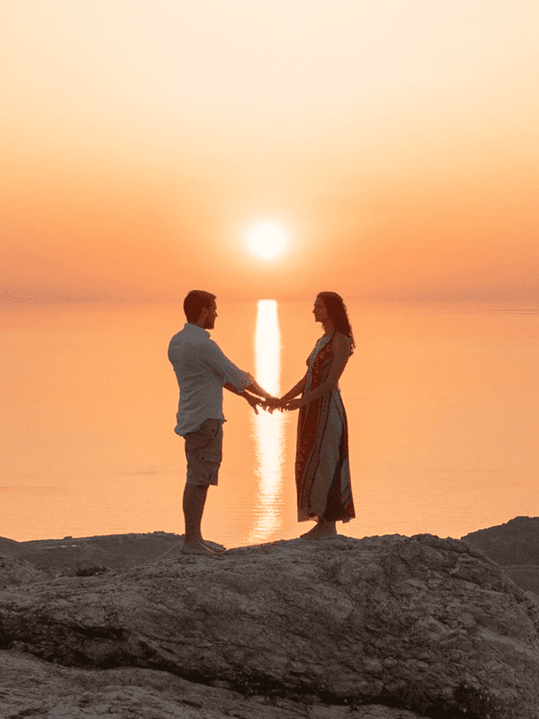 Romantic couple holding hands on beach at sunset with reflection in water, love, relationship, sunset scenery, QuestForDirections.