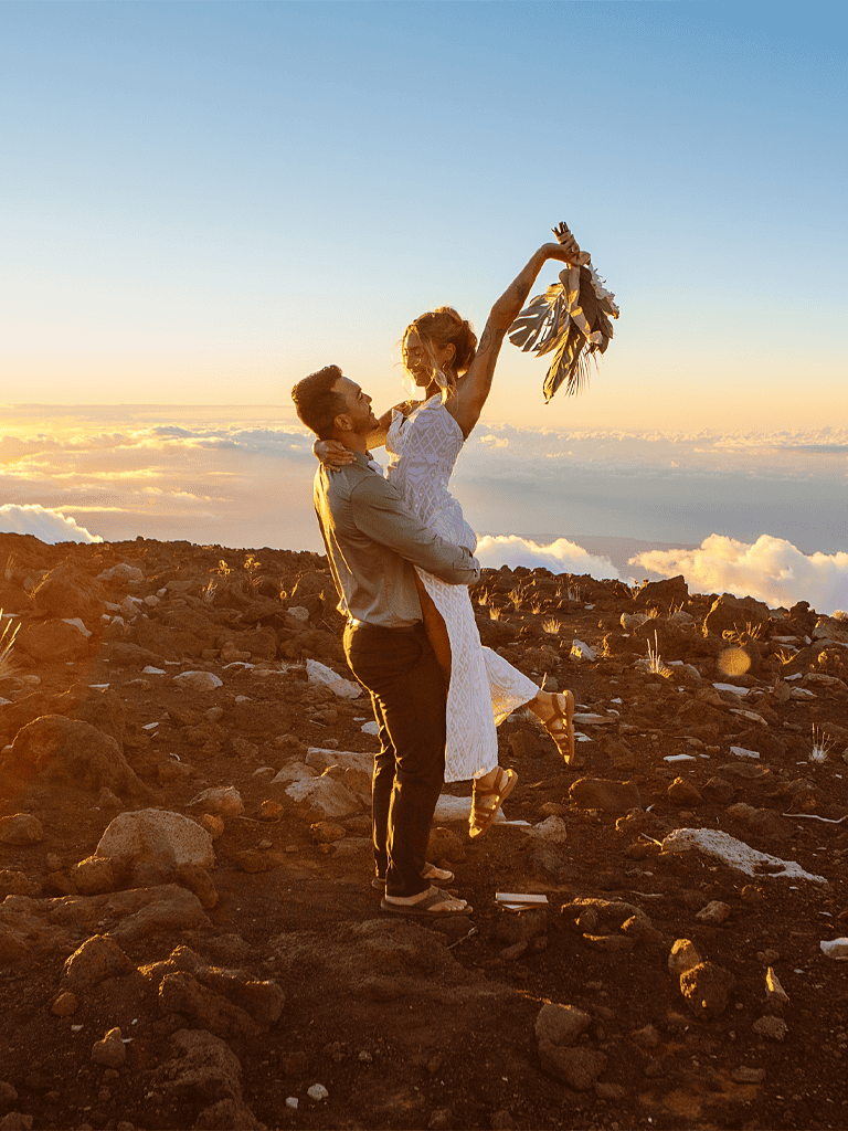 Happy couple dancing on volcanic landscape during sunset, adventure, romance, travel, exploration, QuestForDirections, destination, couple, scenic, passion.