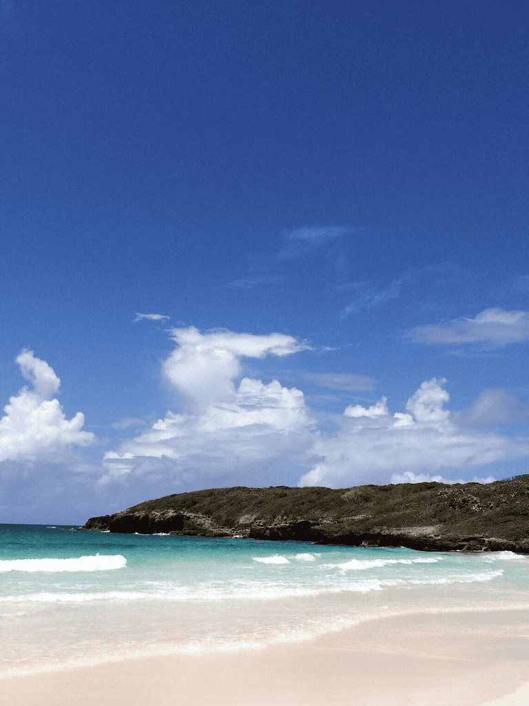 Stunning beach landscape with clear sea and blue sky, ideal for travel and adventure inspiration.