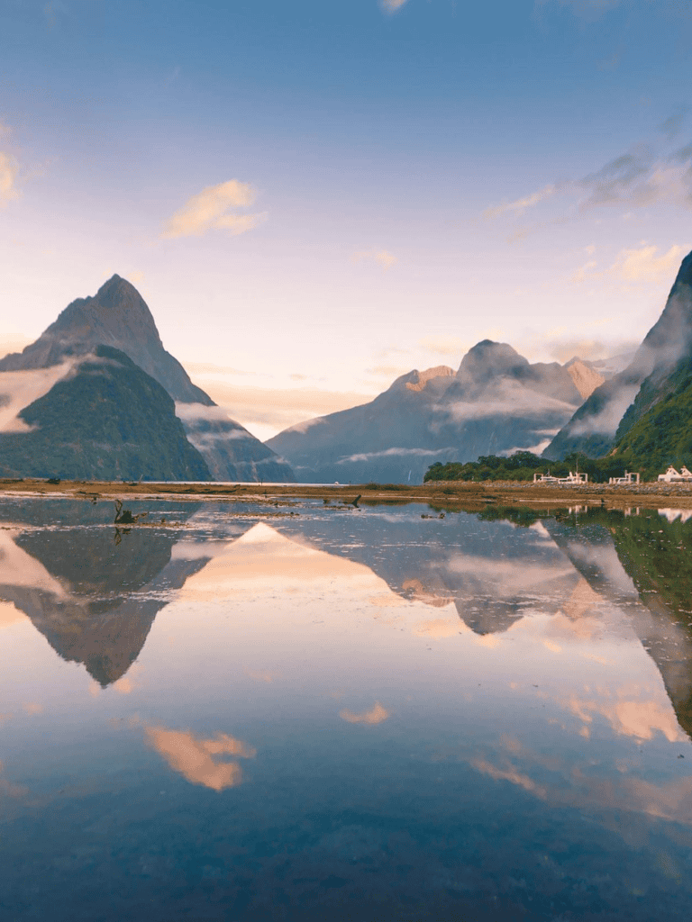 Serene mountainous landscape with reflection in water, exploring natural beauty and adventure travel.
