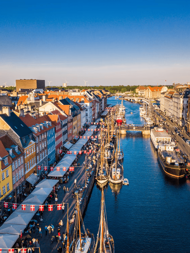 Colorful European harbor with boats and vibrant waterfront buildings, top sightseeing destination.