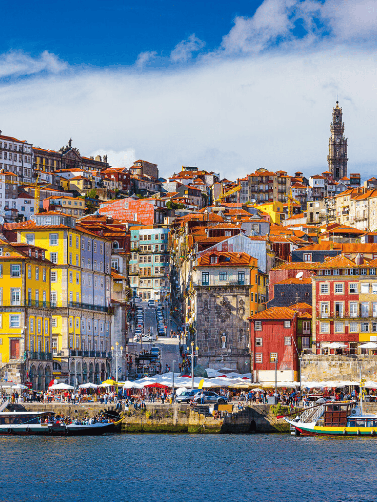 Colorful Portuguese cityscape with stacked houses and waterfront scenery, Lisbon travel guide, Portugal tourism destinations.
