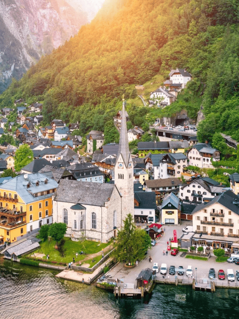 Charming lakeside village in Austria with colorful buildings and scenic mountain views.