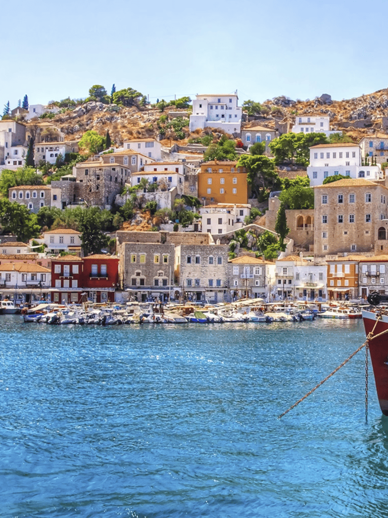 Colorful hillside town with boats by the water, perfect for travel destination and scenic tours.