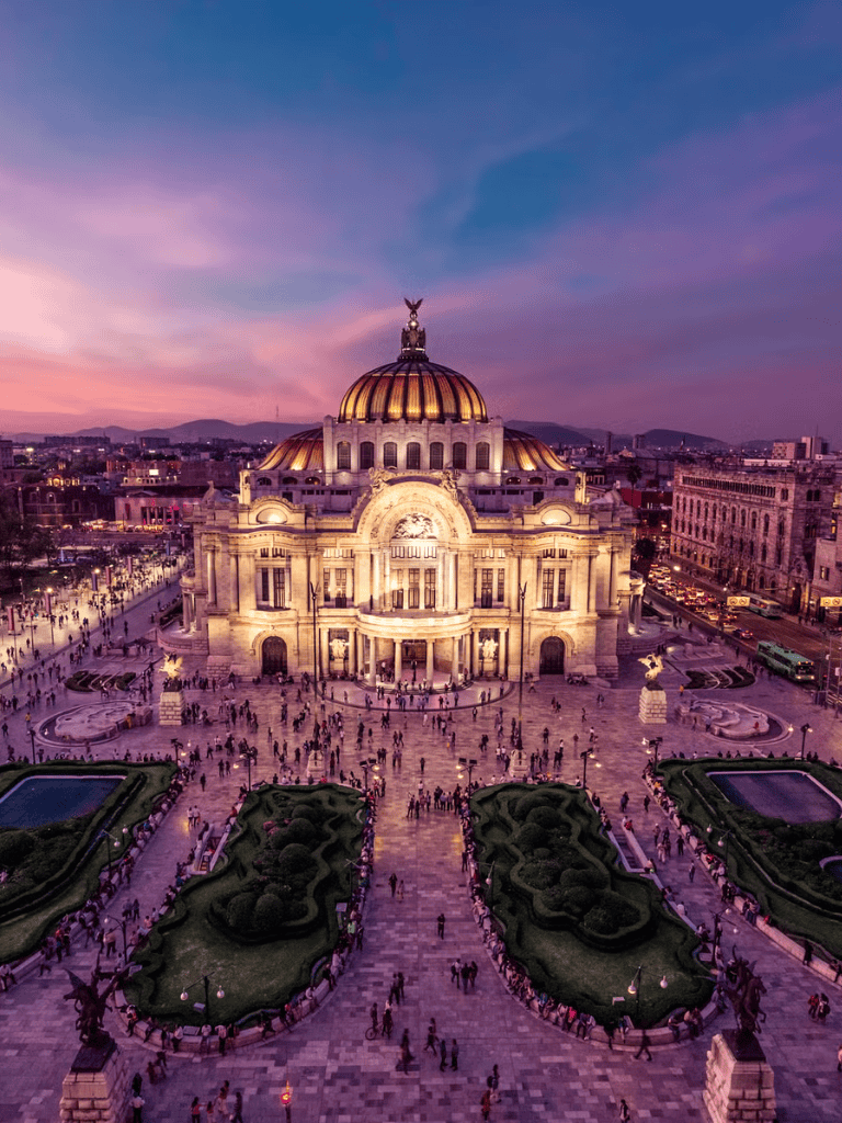 Historic Palace of Fine Arts in Mexico City at sunset, popular destination for tours and cultural visits.