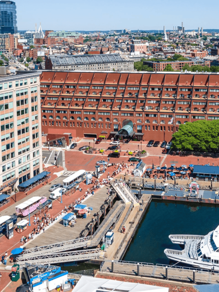 Vibrant city harbor with boats, waterfront attractions, and bustling crowds in downtown Nashville, Tennessee.