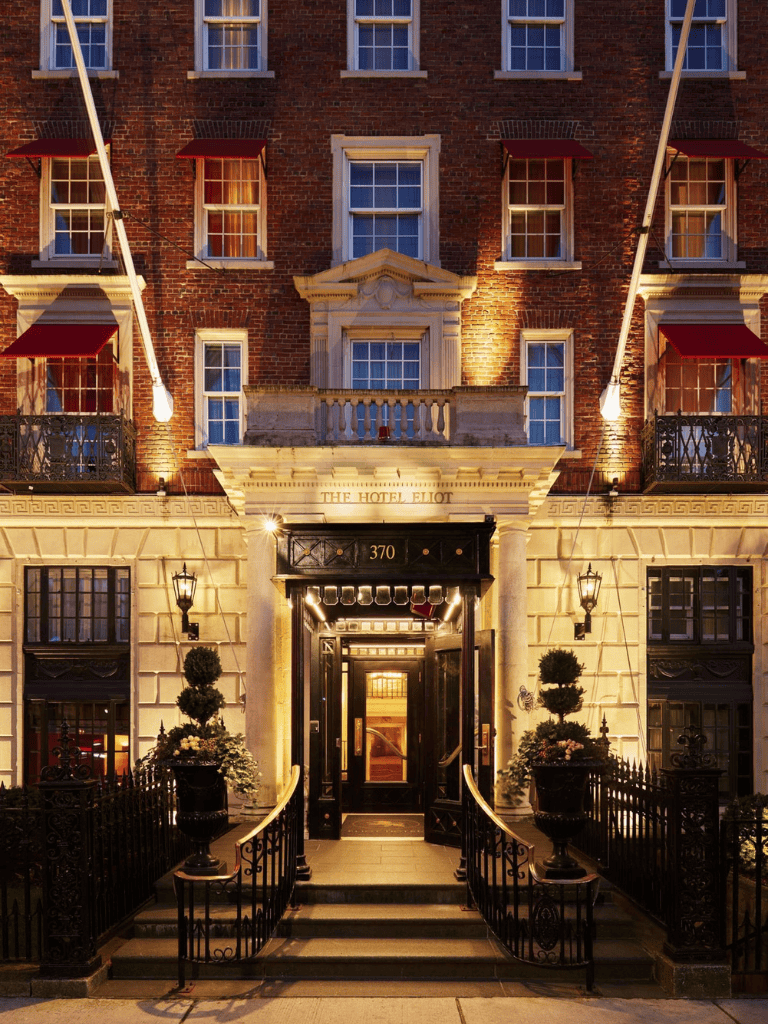 Charming hotel facade illuminated at night, offering luxury accommodations and elegant architecture.