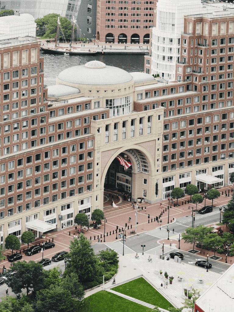 Elegant downtown hotel with grand archway and waterfront views.