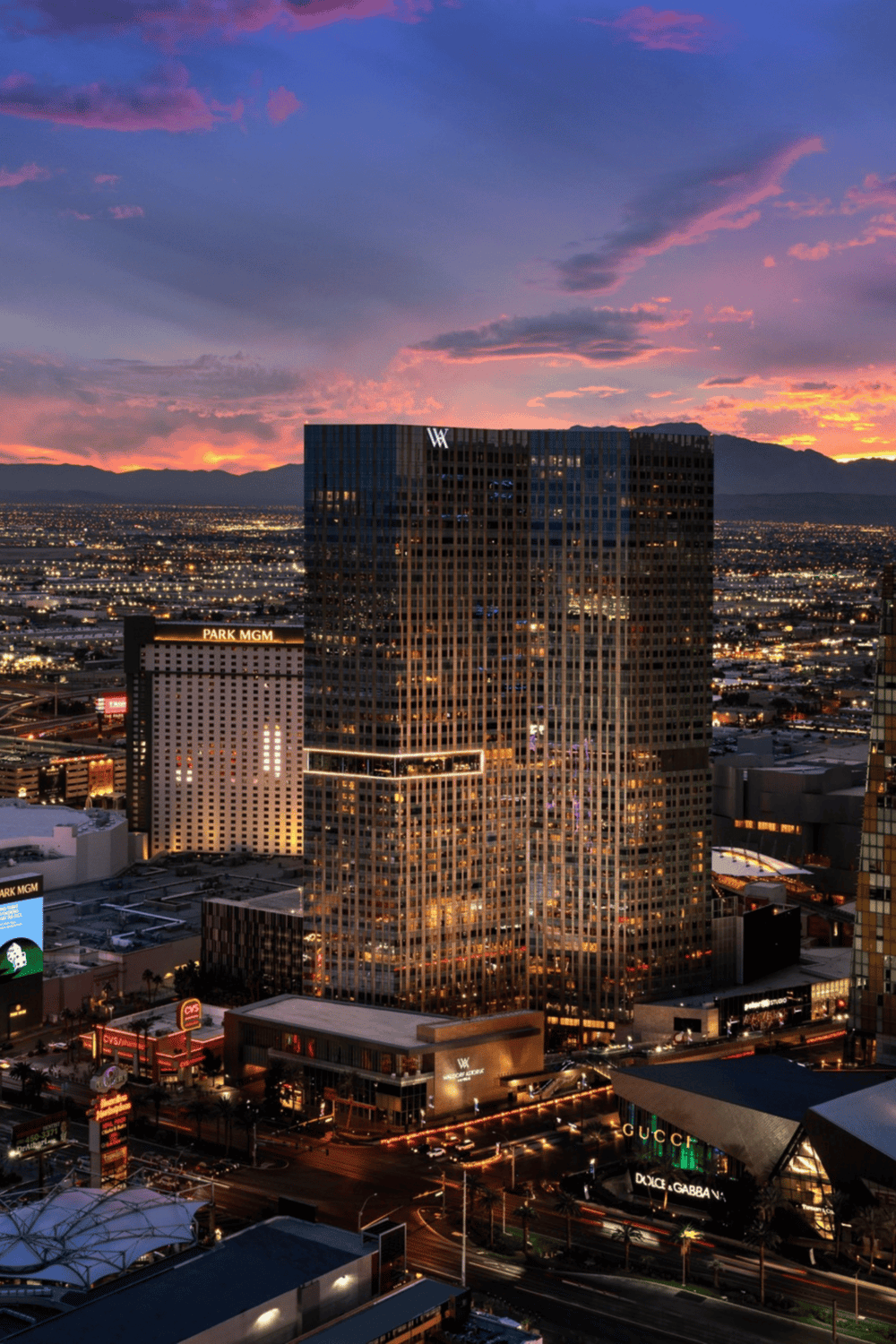Modern Las Vegas hotel building with cityscape views at sunset, featuring high-rise architecture and illuminated streets.