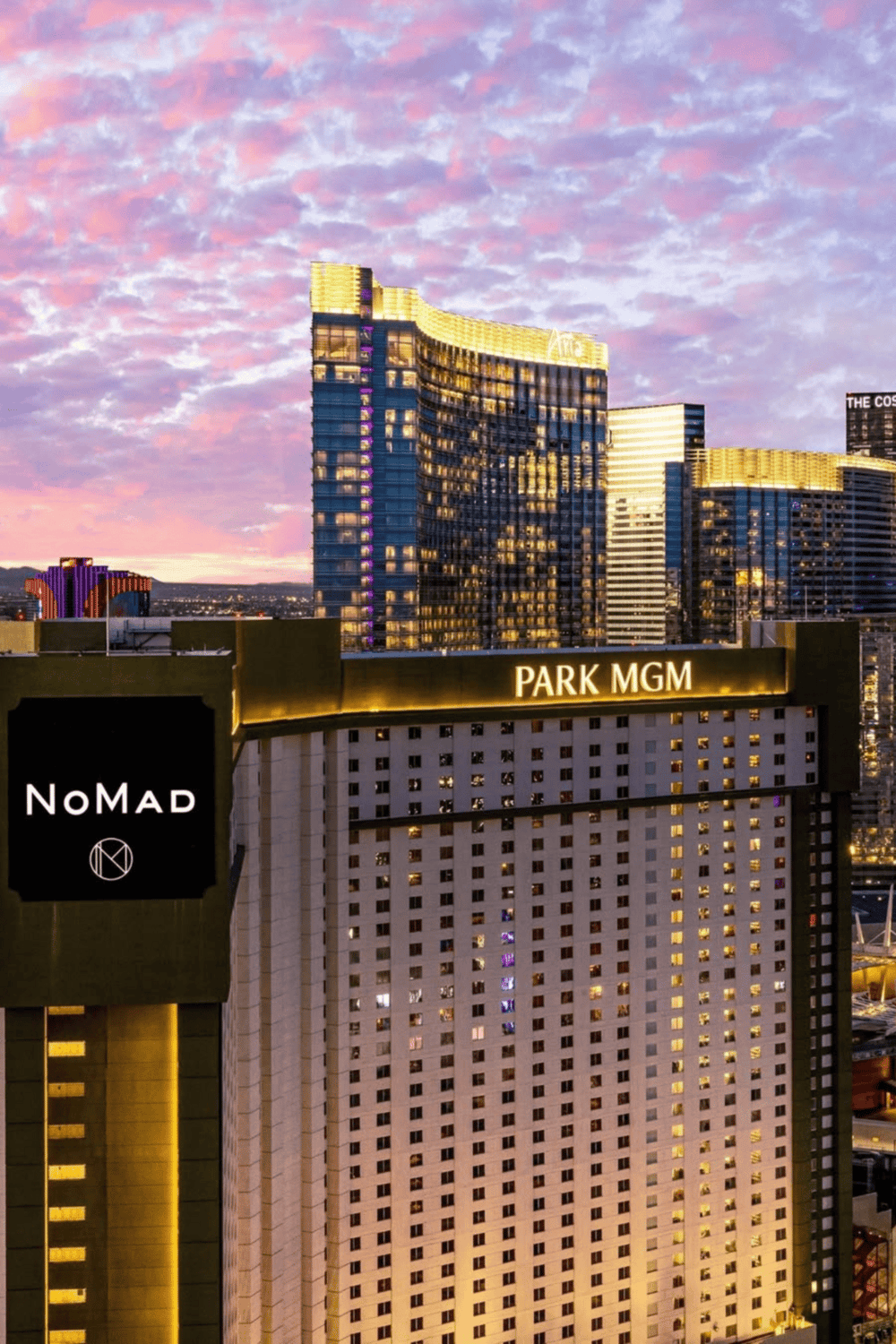 Modern Las Vegas skyline with Park MGM hotel and Nomad sign, vibrant nightlife and travel destination.
