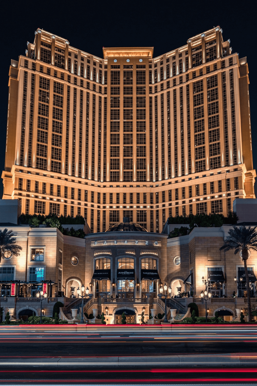 Luxurious hotel at night with illuminated facade, part of Quest For Directions search.