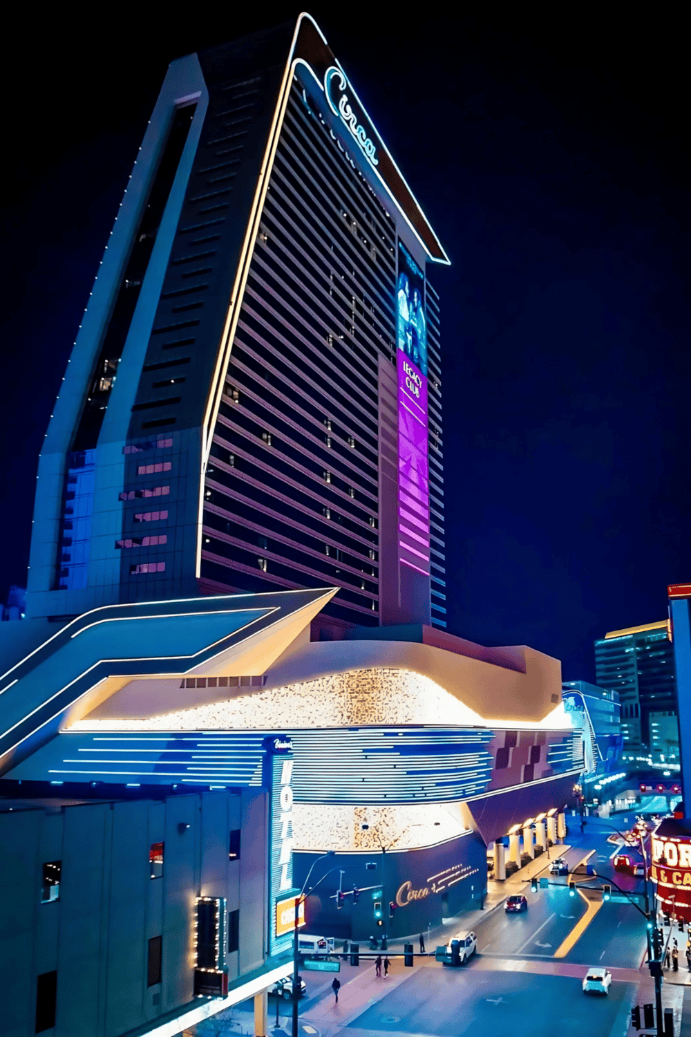 Upscale modern casino hotel lit up at night in downtown Las Vegas, offering luxury gaming and entertainment experiences.