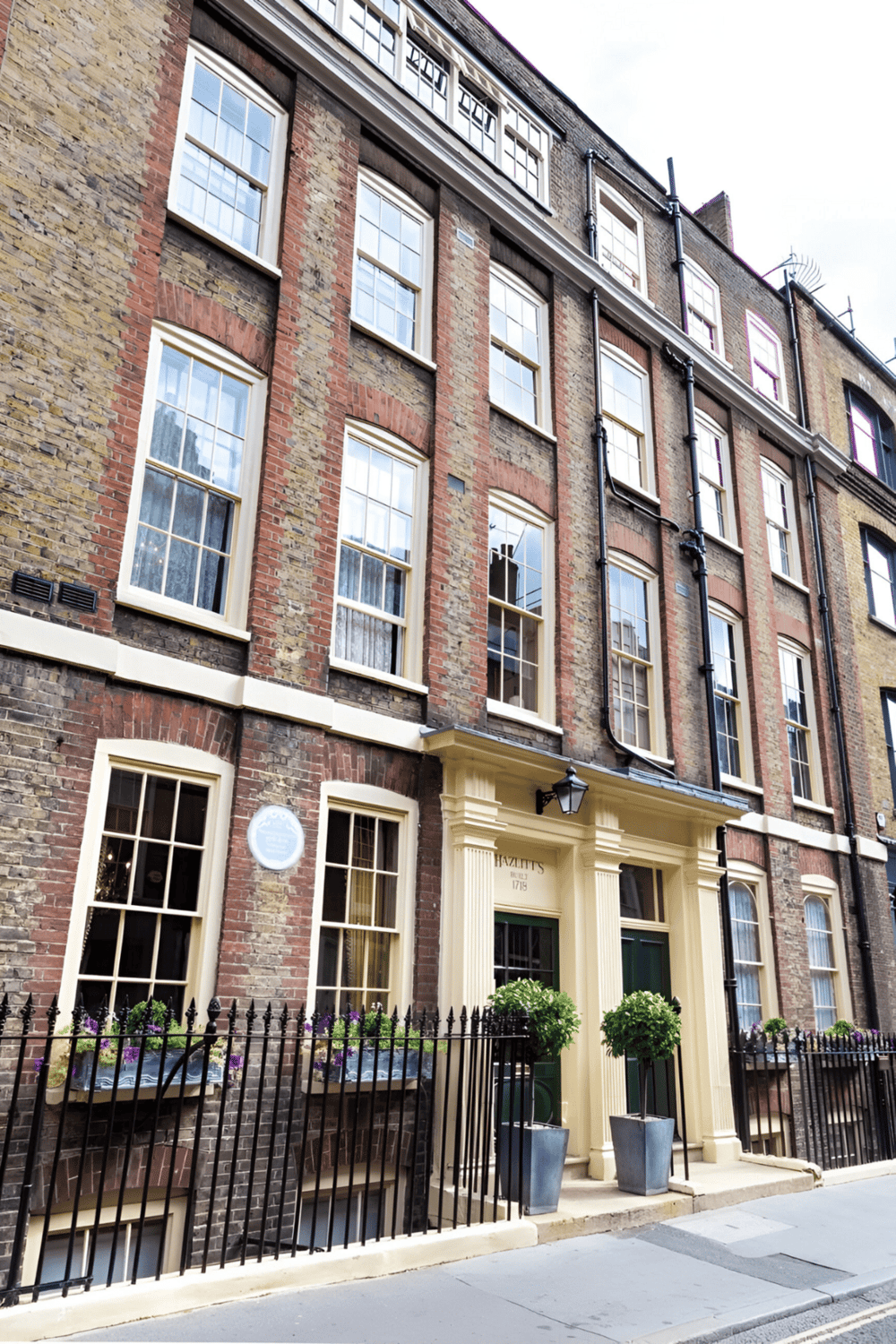 Historic brick apartment building with classic architecture in an urban setting.